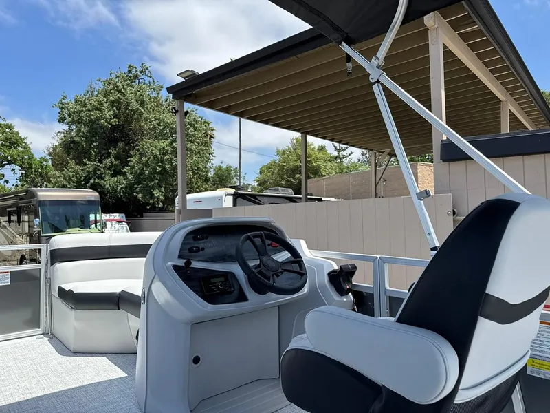 Slide: The Image of 2025 South Bay 18CR SE S Cruise pontoon boat interior with helm and seating. - 11