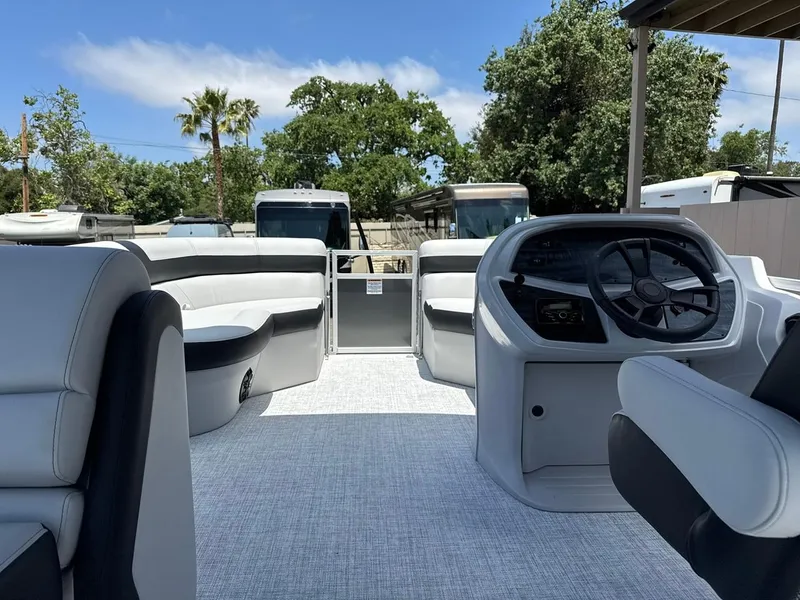 Slide: The Image of 2025 South Bay 18CR SE S Cruise pontoon boat interior with modern seating and steering console. - 12