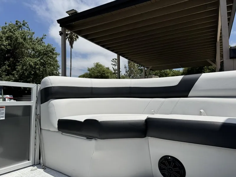 Slide: The Image of 2025 South Bay 18CR SE S Cruise boat interior with white and black seating under a canopy. - 14