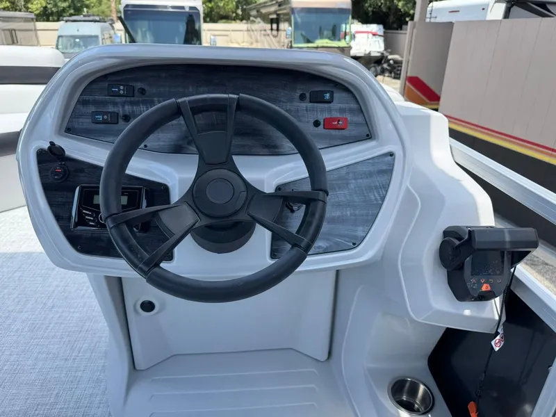 Slide: The Image of Steering console of 2025 South Bay 18CR SE S Cruise boat, featuring modern controls. - 16