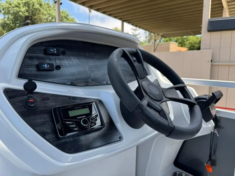 Slide: The Image of 2025 South Bay 18CR SE S Cruise boat dashboard with steering wheel and controls. - 17