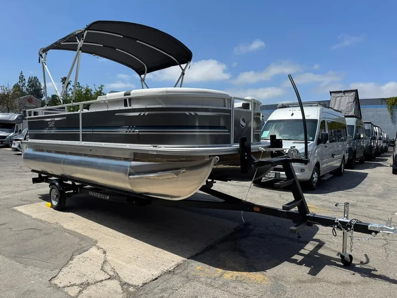 Slide: The Image of 2025 South Bay 18CR SE S Cruise pontoon boat on trailer, parked outdoors. - 2