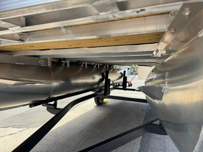 Slide: The Image of Underneath view of 2025 South Bay 18CR SE S Cruise pontoon boat on trailer. - 20