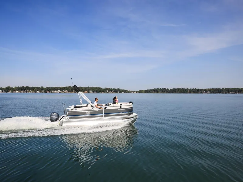 Slide: The Image of 2025 South Bay 18CR SE S Cruise pontoon boat on a serene lake. - 26