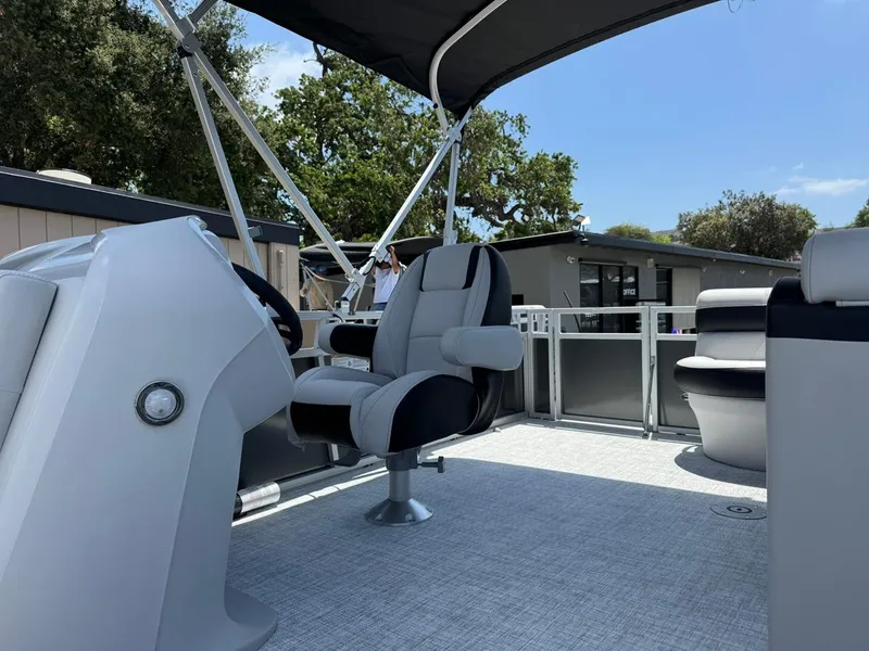 Slide: The Image of 2025 South Bay 18CR SE S Cruise pontoon boat interior with captain's chair and canopy. - 7