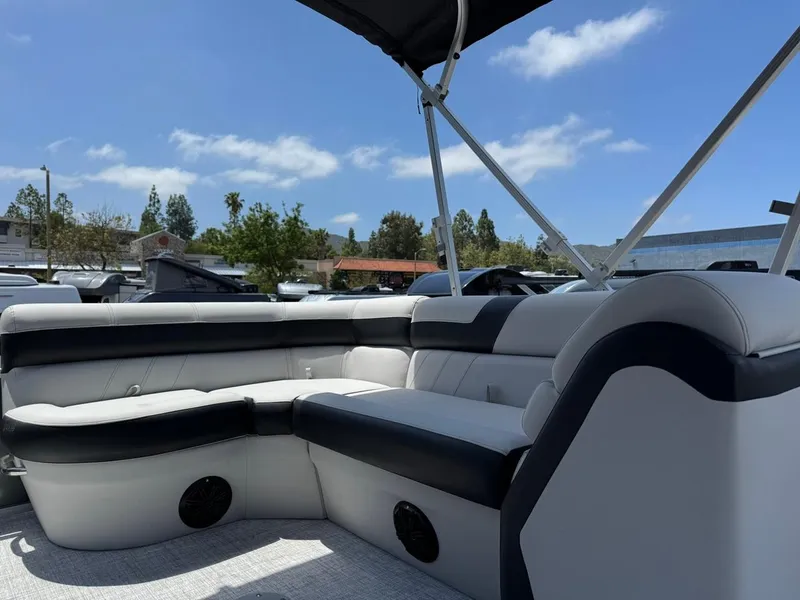Slide: The Image of 2025 South Bay 18CR SE S Cruise pontoon boat interior with cushioned seating under a canopy. - 8