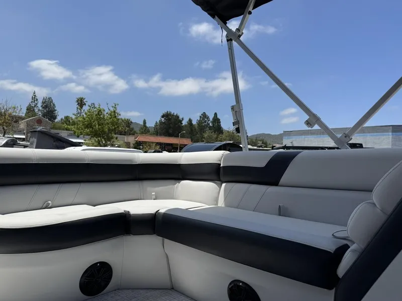 Slide: The Image of 2025 South Bay 18CR SE S Cruise boat interior with cushioned seating under a clear sky. - 9