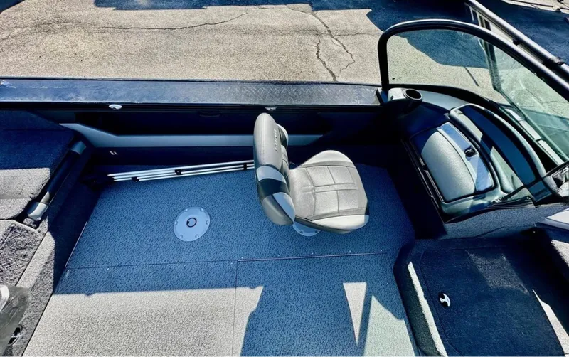 Slide: The Image of 2025 Lund 1875 Crossover XS boat interior with seating and console. - 12