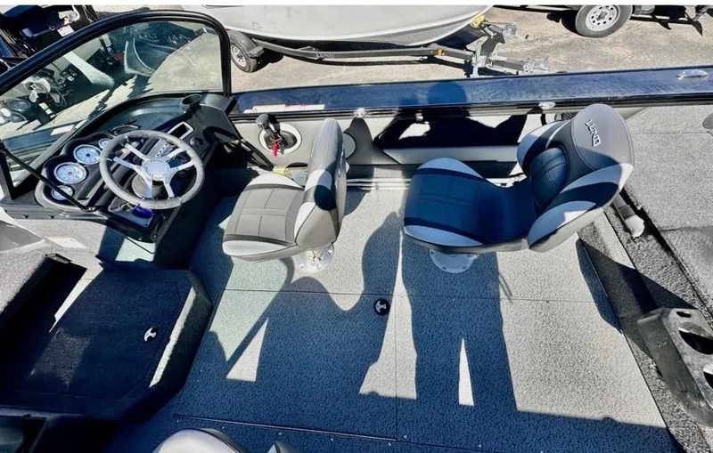 Slide: The Image of 2025 Lund 1875 Crossover XS boat interior with steering wheel and seating. - 14