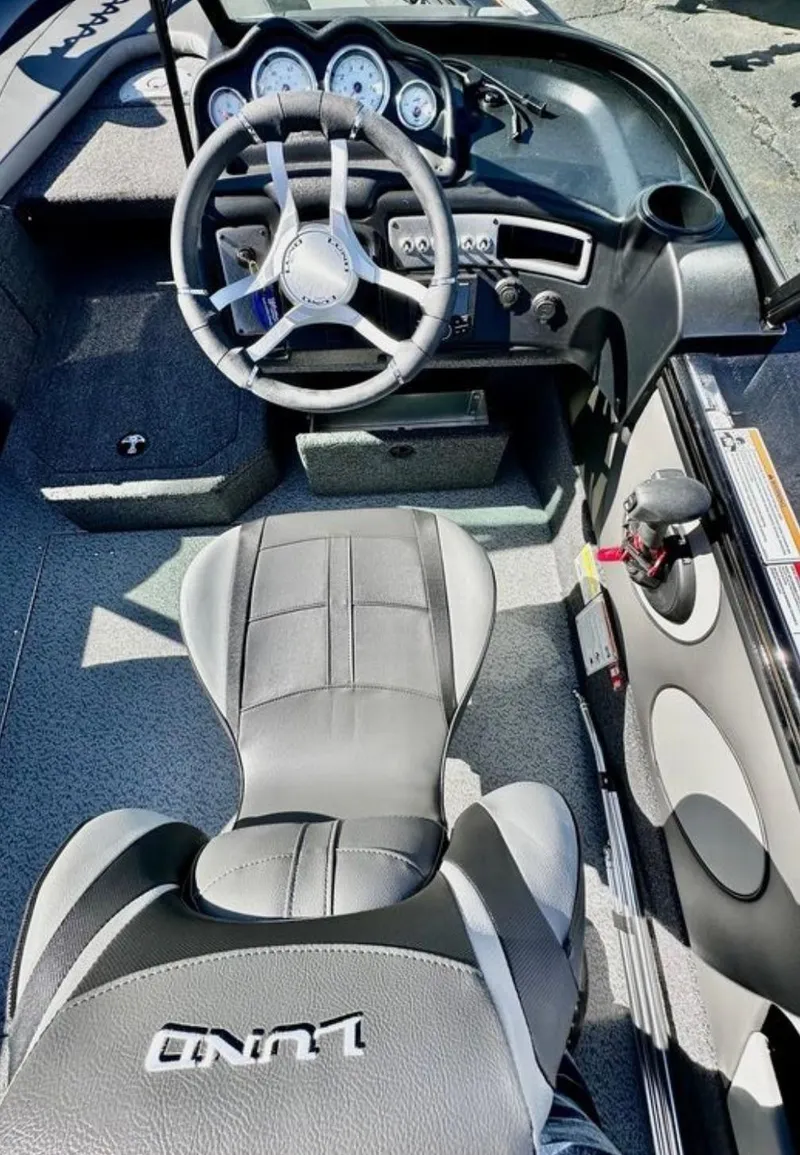 Slide: The Image of 2025 Lund 1875 Crossover XS boat interior with steering wheel and dashboard. - 15