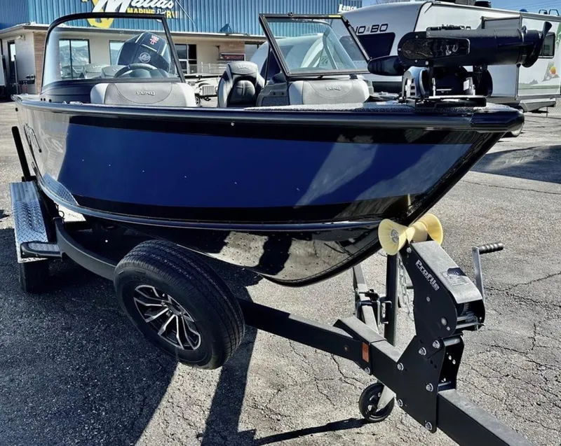 Slide: The Image of 2025 Lund 1875 Crossover XS boat on trailer, parked outdoors. - 5