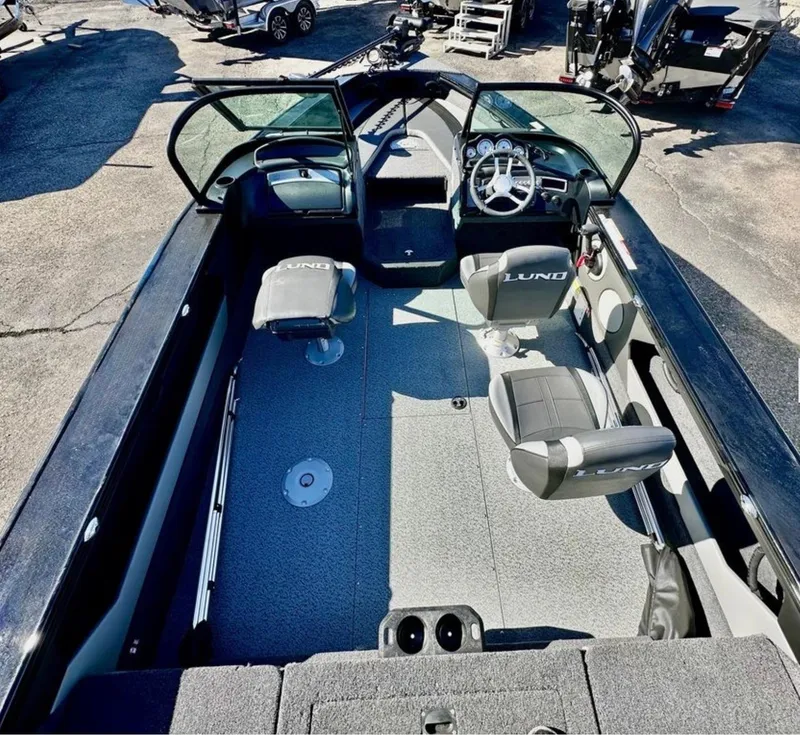 Slide: The Image of 2025 Lund 1875 Crossover XS boat interior with seating and steering wheel. - 6