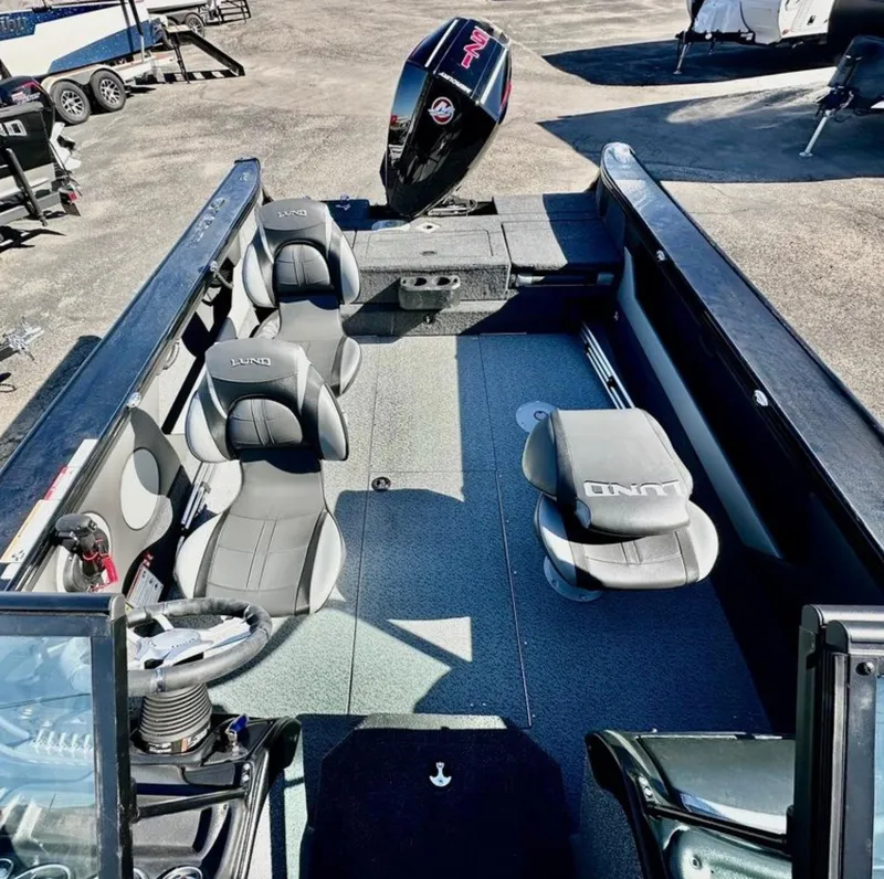 Slide: The Image of 2025 Lund 1875 Crossover XS boat interior with seating and steering wheel. - 7