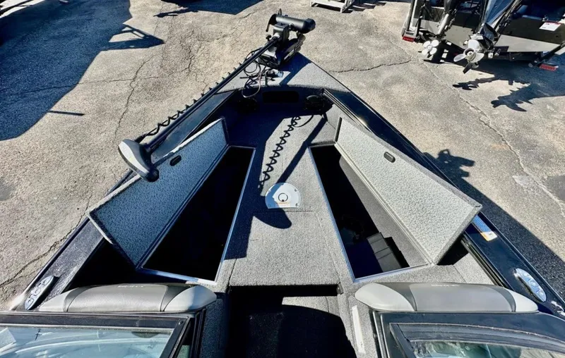 Slide: The Image of 2025 Lund 1875 Crossover XS boat interior with open storage compartments. - 9