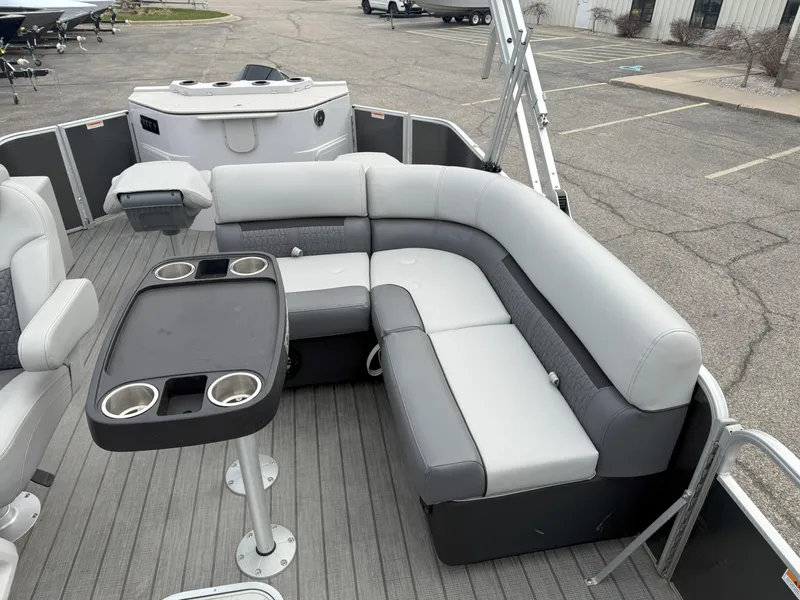Slide: The Image of 2023 Godfrey Sweetwater 2286 FS pontoon boat interior with gray seating and table. - 11