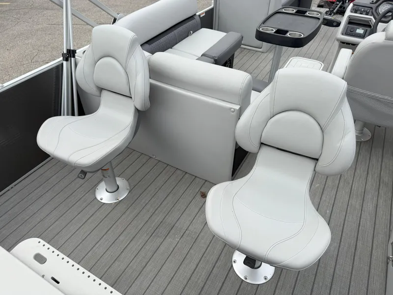 Slide: The Image of 2023 Godfrey Sweetwater 2286 FS boat interior with gray seating and cup holders. - 12
