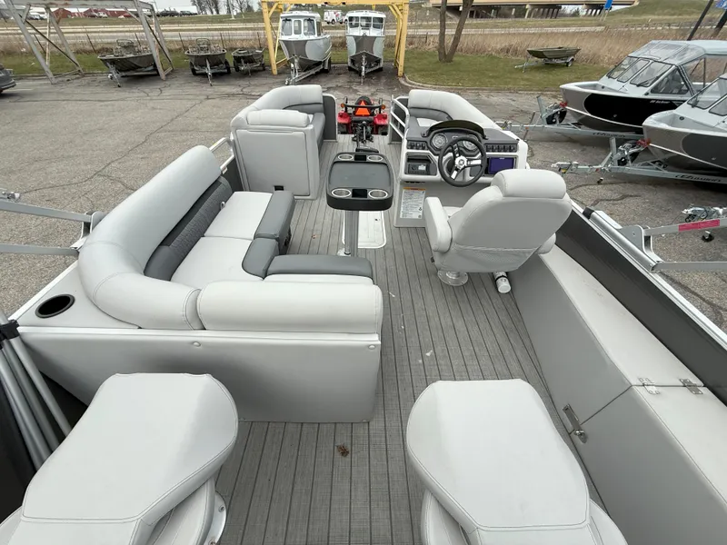 Slide: The Image of 2023 Godfrey Sweetwater 2286 FS pontoon boat interior with gray seating and steering console. - 14