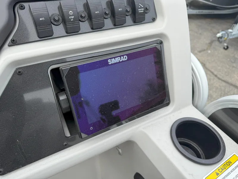 Slide: The Image of 2023 Godfrey Sweetwater 2286 FS dashboard with Simrad display and control panel. - 17