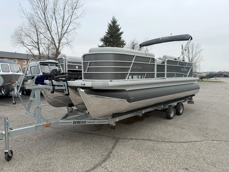 Slide: The Image of 2023 Godfrey Sweetwater 2286 FS pontoon boat on Genesis trailer in parking lot. - 2