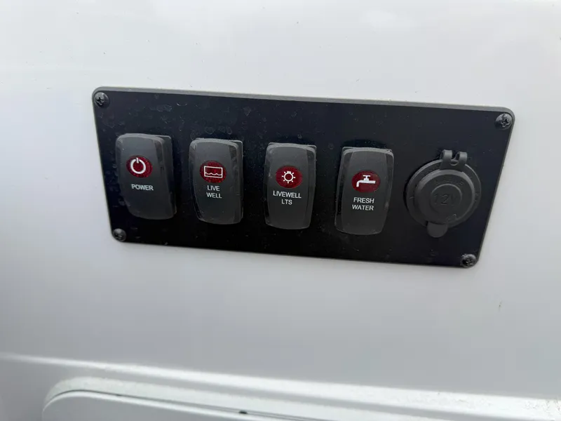 Slide: The Image of Control panel on 2023 Godfrey Sweetwater 2286 FS boat with labeled switches. - 21