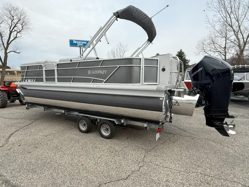 Slide: The Image of 2023 Godfrey Sweetwater 2286 FS pontoon boat on trailer, parked outdoors. - 3