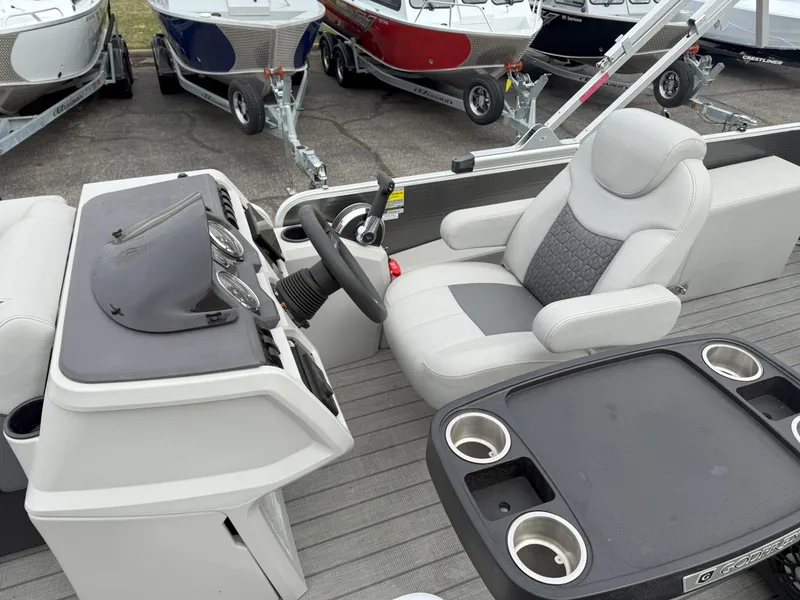 Slide: The Image of 2023 Godfrey Sweetwater 2286 FS boat interior with steering console and seating. - 9