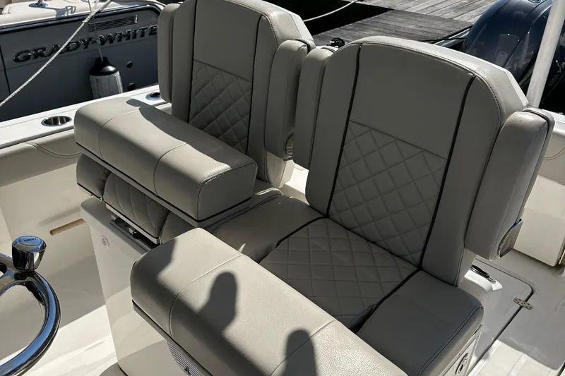 Slide: The Image of 2024 Pursuit S 268 boat seats with quilted upholstery and steering wheel. - 14