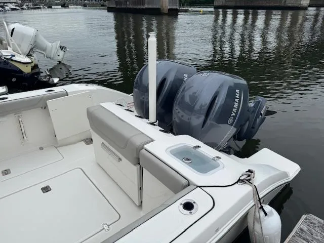 Slide: The Image of 2024 Pursuit S 268 boat with dual Yamaha engines docked by the water. - 18