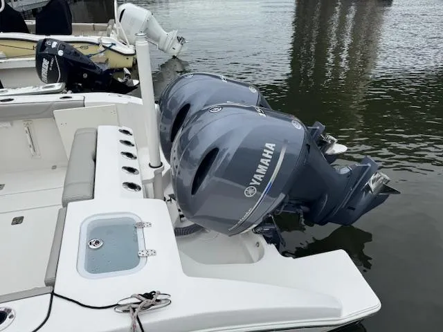 Slide: The Image of 2024 Pursuit S 268 boat with dual Yamaha outboard motors on calm water. - 21