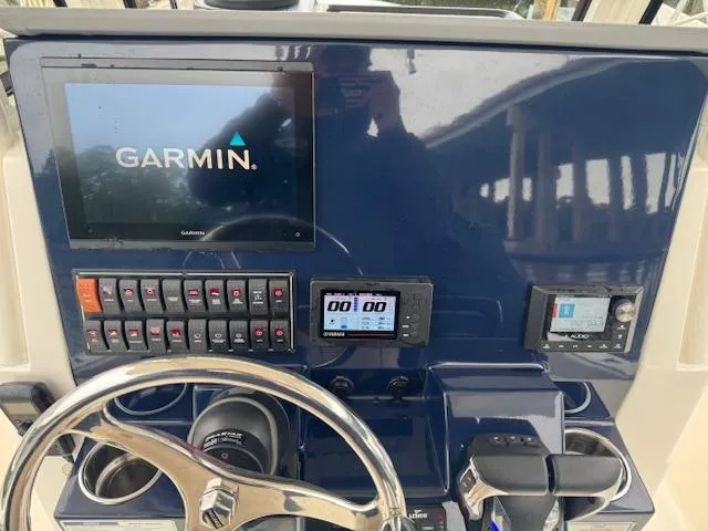 Slide: The Image of 2024 Pursuit S 268 boat dashboard with Garmin navigation system and control panel. - 23