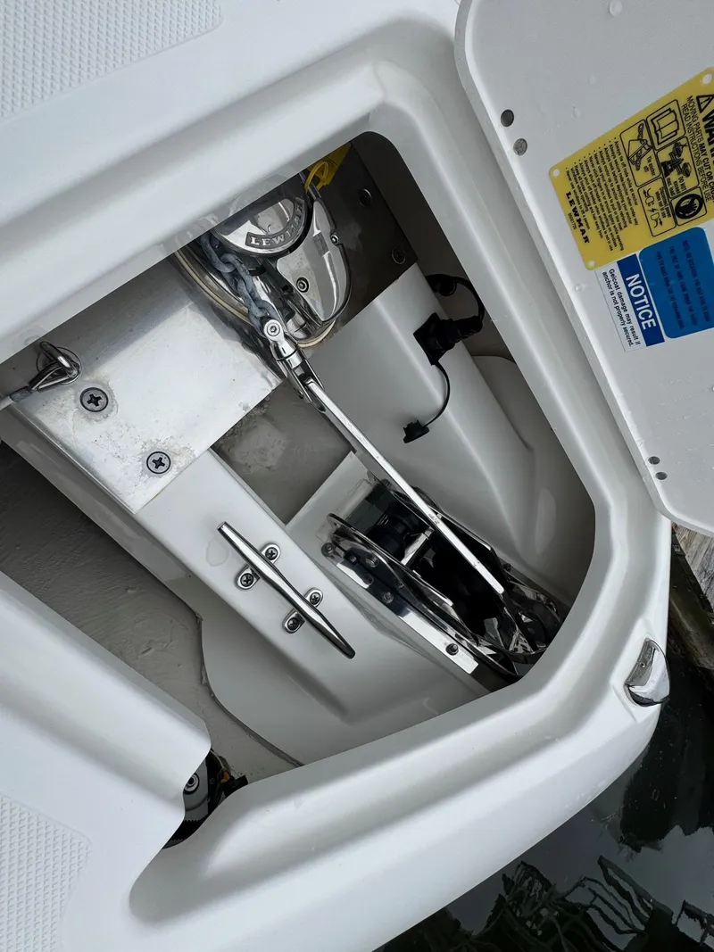Slide: The Image of 2024 Pursuit S 268 boat anchor compartment with mechanical details. - 27