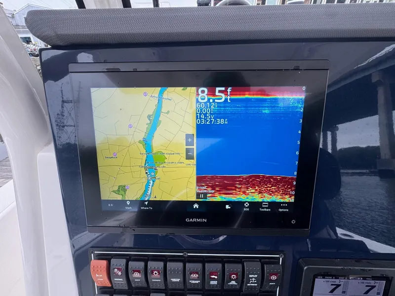 Slide: The Image of 2024 Pursuit S 268 boat with Garmin navigation display showing map and sonar data. - 28