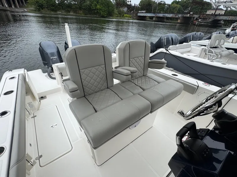 Slide: The Image of 2024 Pursuit S 268 boat interior with gray seating and water view. - 31