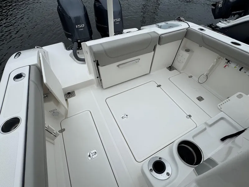 Slide: The Image of 2024 Pursuit S 268 boat deck with seating, storage, and dual engines. - 32