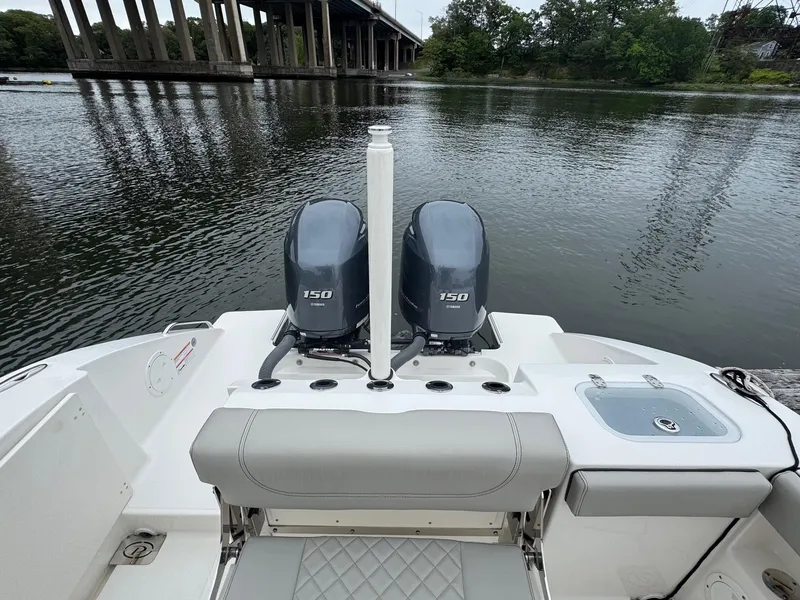 Slide: The Image of 2024 Pursuit S 268 boat with dual 150 engines on a calm river. - 34