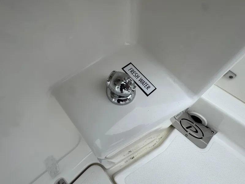 Slide: The Image of 2024 Pursuit S 268 boat fresh water access point with chrome fixture. - 36