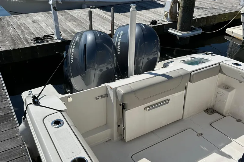 Slide: The Image of 2024 Pursuit S 268 boat with dual Yamaha outboard engines docked at marina. - 9