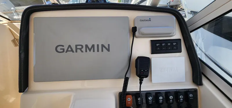 Slide: The Image of Control panel of 2023 Grady-White Freedom 235 with Garmin navigation system. - 13