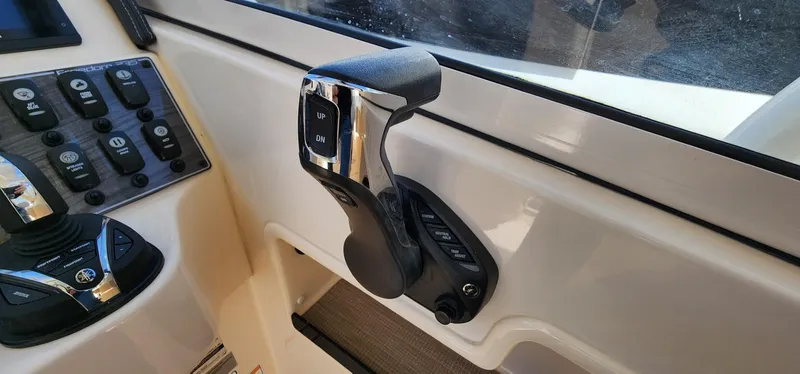 Slide: The Image of Throttle control of 2023 Grady-White Freedom 235 boat, featuring sleek design and ergonomic handle. - 16