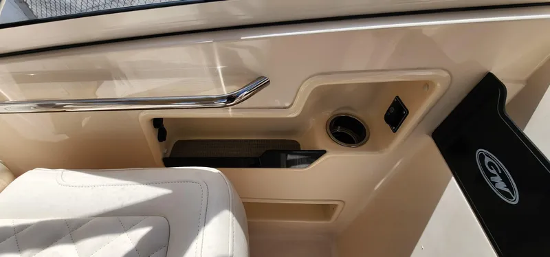 Slide: The Image of Interior of 2023 Grady-White Freedom 235 boat, featuring beige upholstery and chrome accents. - 17
