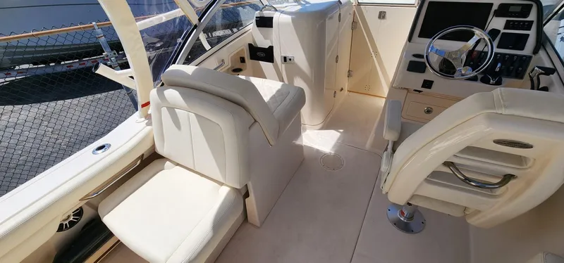 Slide: The Image of 2023 Grady-White Freedom 235 boat interior with helm, seating, and modern controls. - 18