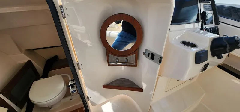 Slide: The Image of 2023 Grady-White Freedom 235 boat interior with toilet and mirror. - 23