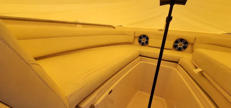 Slide: The Image of 2023 Grady-White Freedom 235 boat interior with beige seating and speakers. - 25