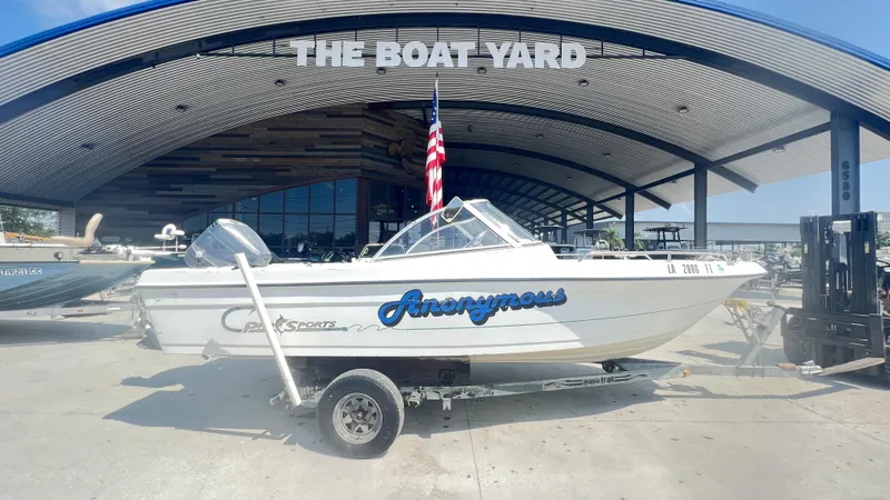 Slide: The Image of Open deck of a 1998 Pro Sports Walk Through boat in a marina. - 1