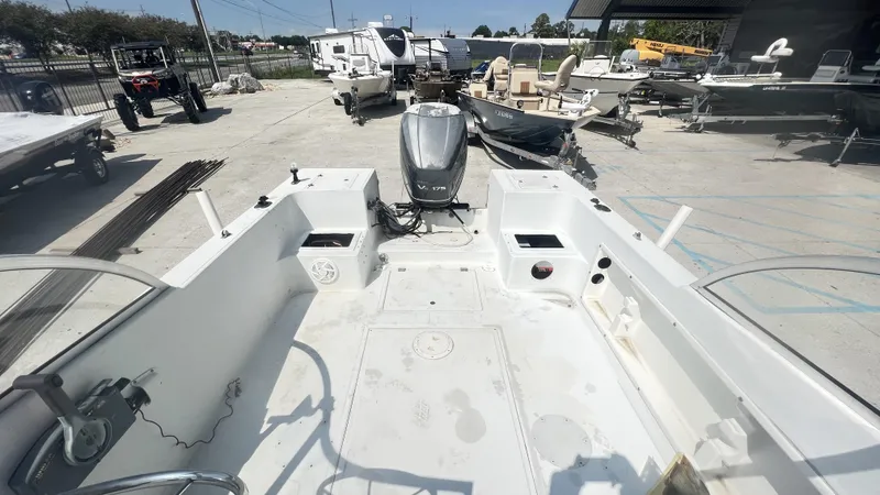 Slide: The Image of 1998 Pro Sports Walk Through boat on trailer, parked outdoors under clear blue sky. - 2