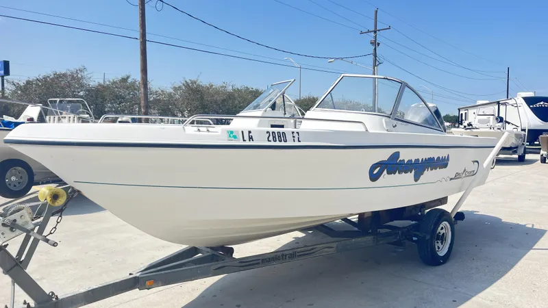 Slide: The Image of 1998 Pro Sports Walk Through boat with outboard motor in a marina setting. - 3