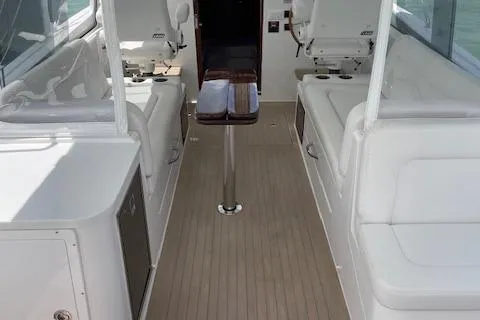 Slide: The Image of 2023 MJM 35z boat interior with white seating and wooden flooring. - 13
