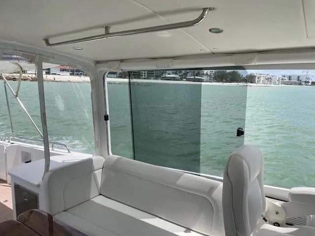 Slide: The Image of Interior view of 2023 MJM 35z yacht with white seating and ocean backdrop. - 17