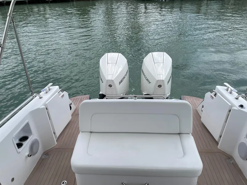 Slide: The Image of 2023 MJM 35z boat with dual Mercury outboard engines on calm water. - 20