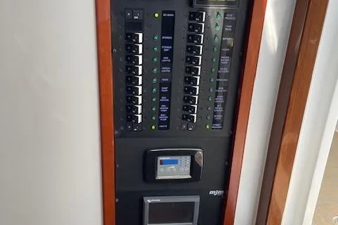 Slide: The Image of Electrical control panel on a 2023 MJM 35z boat, featuring switches and displays. - 25